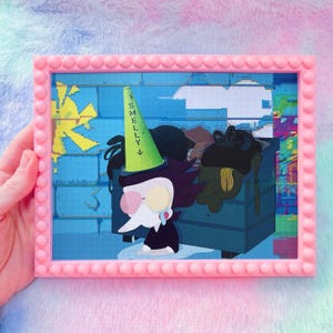 May include: A pink framed art print featuring a cartoon character with a green hat that says "Smelly". The character is in front of a blue dumpster. The background has a blue brick wall and yellow star.