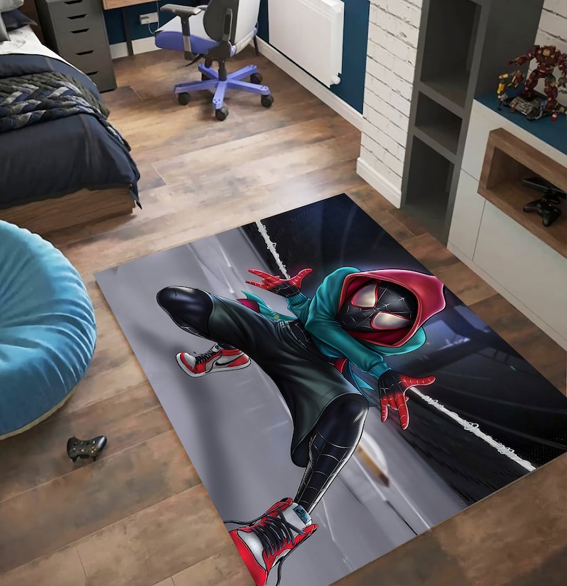 May include: A rug featuring a cartoon illustration of Spider-Man in a red and black suit with a blue and green hoodie. The character is posed in a dynamic action pose with one leg extended and the other bent at the knee. The background is a dark grey with white lines.