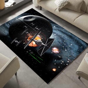 May include: A black and white Star Wars themed rug featuring the Death Star and a TIE fighter in space. The rug has a galaxy background with stars and nebulae.