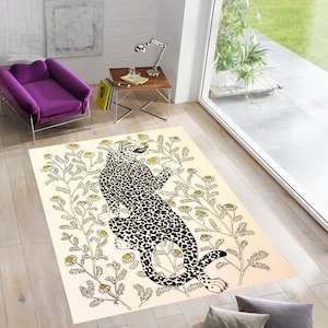 May include: A cream-colored rug with a black and white leopard print design. The leopard is surrounded by yellow flowers and green leaves.