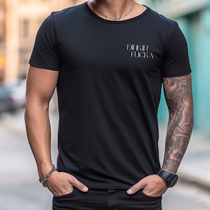 May include: A black t-shirt with the text "DIIKIIH FLICKA" printed on the front.