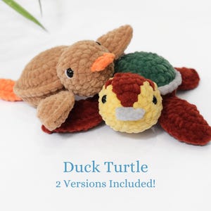 May include: Two crocheted plush toys, a brown duck and a red turtle with a green shell. The toys are made with a soft, fuzzy yarn. The text "Duck Turtle 2 Versions Included!" is printed below the toys.