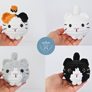 May include: Four crocheted cat plushies in different colors: calico, white, gray, and black. Each plush has a white face with black eyes and a pink nose.