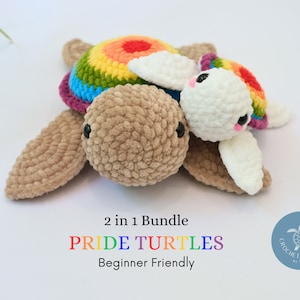 May include: Two crocheted turtle amigurumi toys. The larger turtle has a rainbow coloured shell and a brown body. The smaller turtle is white with a rainbow coloured shell. The text "2 in 1 Bundle PRIDE TURTLES Beginner Friendly" is below the turtles.