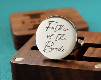 May include: Silver cufflinks in a wooden box. The cufflinks are engraved with the text "Father of the Bride".