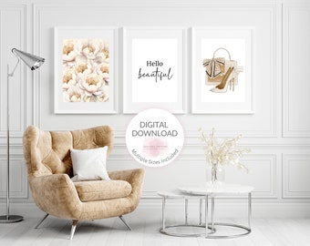 May include: Three printable wall art prints in white frames. The first print features a watercolor illustration of white peonies. The second print features the text "Hello beautiful". The third print features a watercolor illustration of a white handbag with a gold bow and a pair of white high heels.