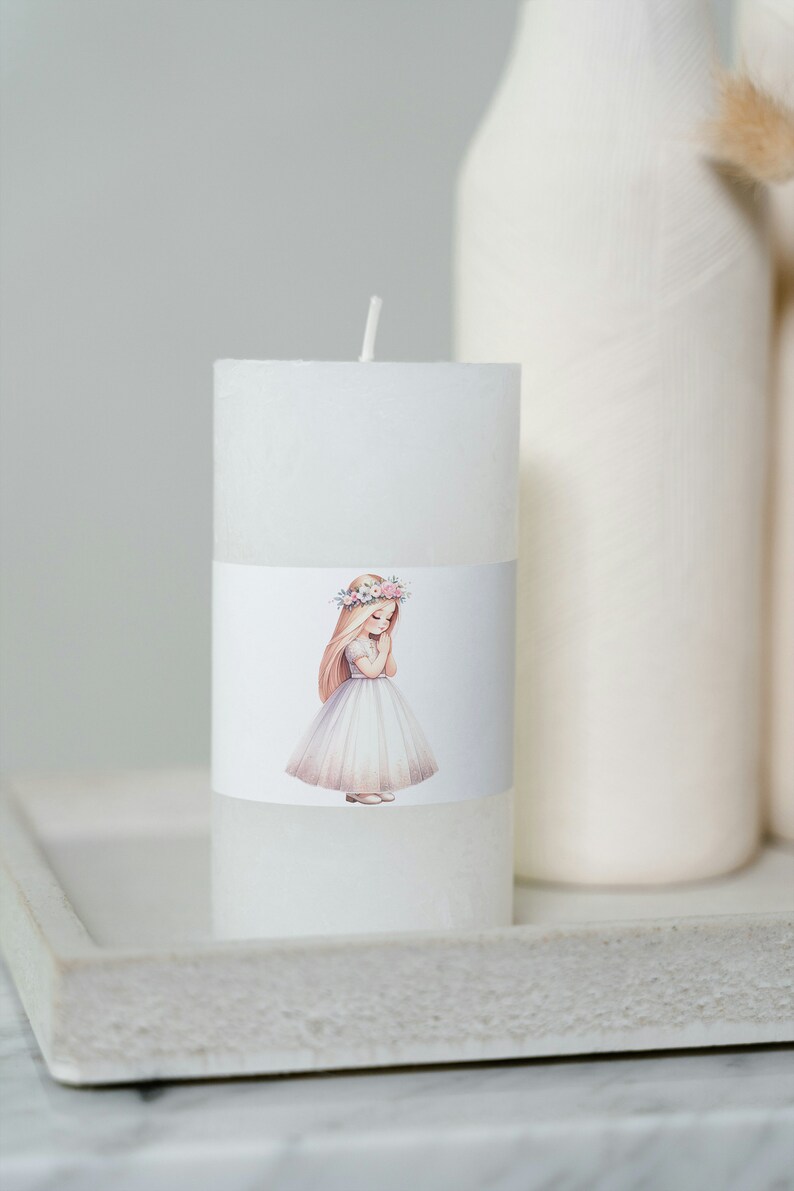 May include: White pillar candle with a floral wreath and a girl in a white dress on the label.