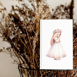 May include: A white card with a watercolor illustration of a girl in a white dress and a flower crown. The girl is holding her hands together in a prayer position.