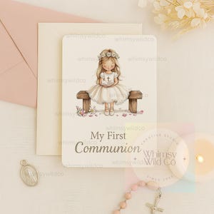 May include: A white card with a watercolor illustration of a girl in a white dress holding a book. The girl is sitting on a wooden bench with flowers and petals around her. The text "My First Communion" is printed on the card.