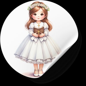May include: A young girl in a white dress and a flower crown holds a book with a cross on it. She is wearing a necklace with a cross pendant.