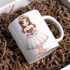 May include: White ceramic mug with a colorful illustration of a girl in a white dress and a flower crown holding a book. The girl has brown hair and blue eyes.