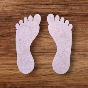 May include: A handmade wooden sign displaying the word "Welcome" in a whimsical font. It has a distressed white backdrop and a dark brown border, suitable for a front door or hallway.