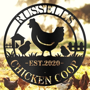 May include: Black metal sign with a chicken, two chicks, and a coop silhouette. The sign is circular with the words "RUSSELL'S CHICKEN COOP - EST. 2020" cut out. The background shows chickens in a field.