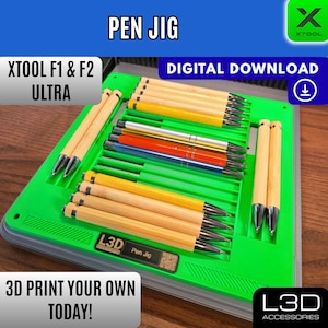 May include: A green pen jig with multiple pens in various colours. The jig has the text "PEN JIG", "XTOOL F1 & F2 ULTRA", and "3D PRINT YOUR OWN TODAY!". The pens are made of wood and metal.