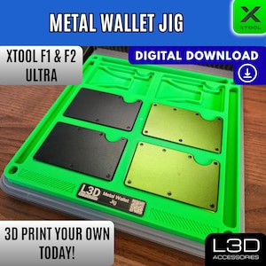 May include: A green metal wallet jig with four slots, two holding black wallets and two holding gold wallets. Text includes "METAL WALLET JIG", "XTOOL F1 & F2 ULTRA", "DIGITAL DOWNLOAD", and "3D PRINT YOUR OWN TODAY!"