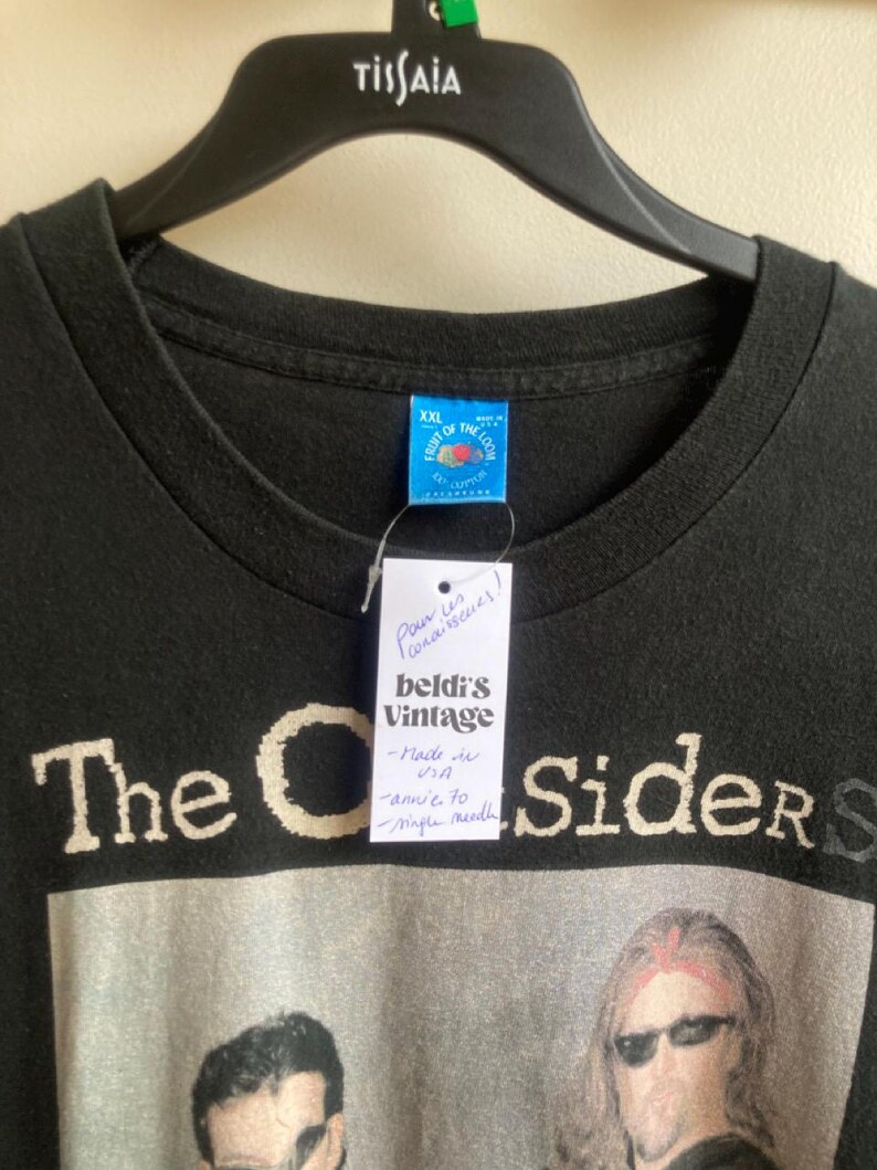 May include: Black t-shirt with a band graphic. The shirt has the text "The C Sider S" in a distressed font. A tag reads "beldi's Vintage" and "Made in USA". The shirt is size XXL and is hanging on a black hanger.