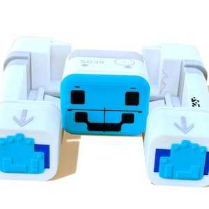 May include: A white and blue robotic device with a central blue square featuring black square details and a horizontal line. The device has the text "SD35" on top and arrow symbols on the sides. The device is designed for educational purposes.