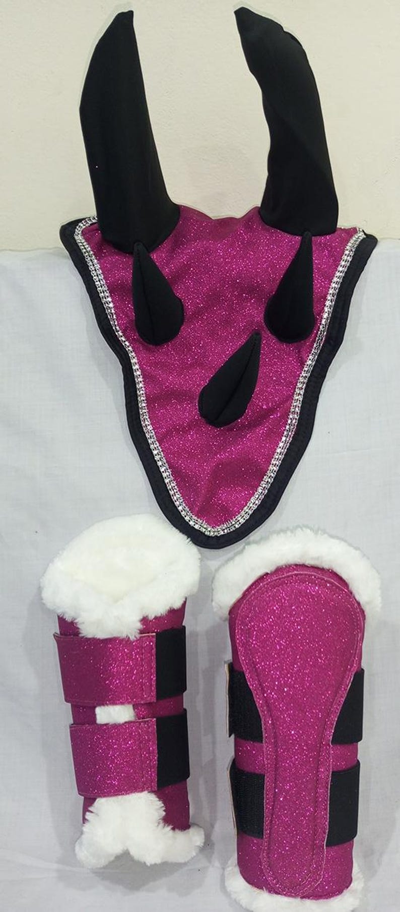 Pink glitter horse fly boots with black straps and white faux fur lining. A pink glitter horse fly bonnet with black ears and rhinestones.