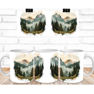 two coffee mugs with a mountain scene on them