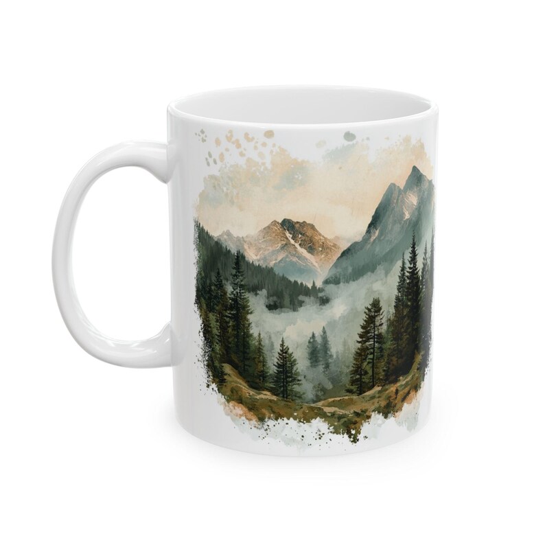 a coffee mug with a mountain scene on it