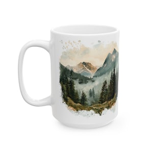 a coffee mug with a mountain scene on it