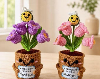 May include: Two crocheted potted plants with smiling faces, each holding a sign that reads A little plant for a big thank you. One pot features purple tulip-like flowers, the other pink, both topped with a small crocheted bee with white wings.
