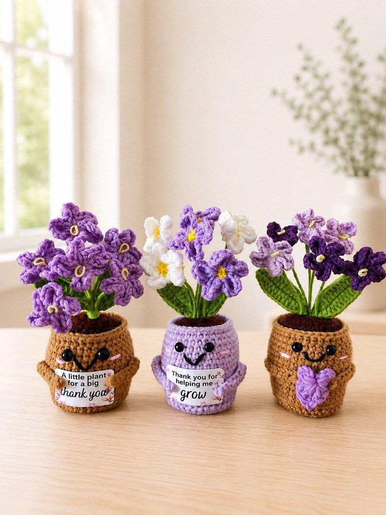 May include: Three crocheted potted plants with smiling faces. The left pot is brown with text reading A little plant for a big thank you. The center pot is light purple with text reading Thank you for helping me grow. The right pot is brown with a heart.