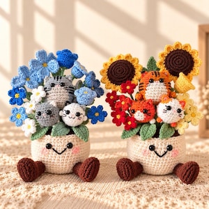 May include: Two crocheted planters with smiling faces and brown feet, each holding a bouquet. The left planter features blue flowers and three gray and white cats. The right planter features sunflowers and red flowers with three orange, white, and tiger-striped cats.