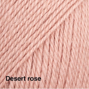 May include: A close-up view of soft, light pink yarn with a visible twisted fibre texture. The yarn is arranged in parallel vertical strands. The text 'Desert rose' is printed in black in the bottom left corner of the image.