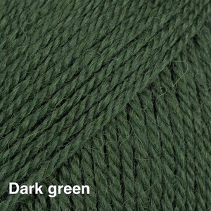 May include: A close-up view of dark green yarn featuring a multi-ply twisted fibre construction with a soft, slightly fuzzy texture. The strands are tightly wound together, creating a consistent vertical pattern across the entire surface.