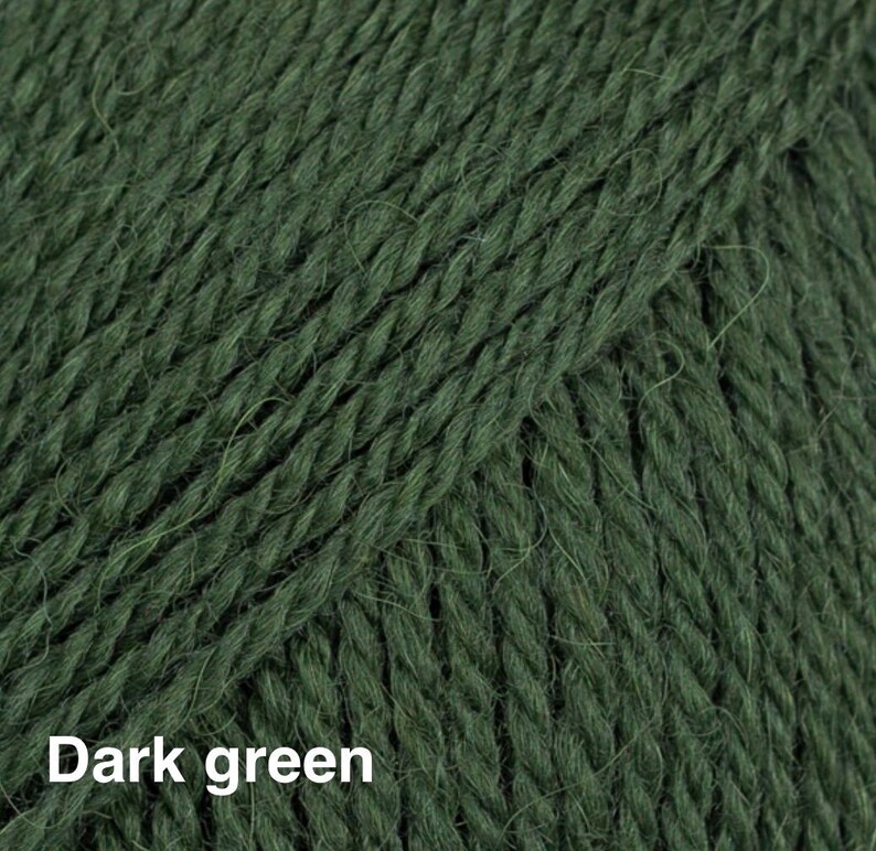 May include: A close-up view of dark green yarn featuring a multi-ply twisted fibre construction with a soft, slightly fuzzy texture. The strands are tightly wound together, creating a consistent vertical pattern across the entire surface.