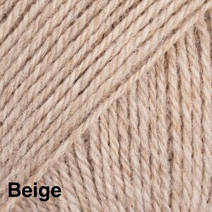May include: A close-up view of beige yarn featuring a multi-ply twisted texture. The fibres are arranged in diagonal lines across the frame, creating a consistent pattern. The word Beige is printed in bold black text in the bottom left corner.