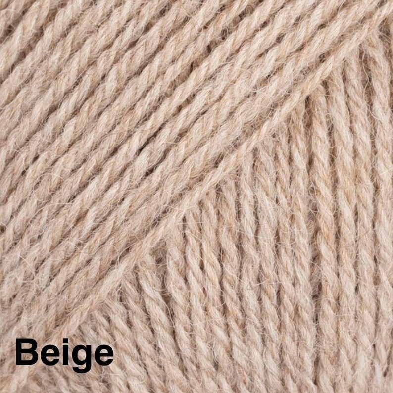 May include: A close-up view of beige yarn featuring a multi-ply twisted texture. The fibres are arranged in diagonal lines across the frame, creating a consistent pattern. The word Beige is printed in bold black text in the bottom left corner.