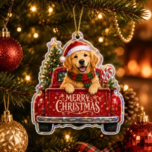 Könnte beinhalten: Ein flacher Weihnachtsbaumschmuck mit einem Golden Retriever, der eine rote Weihnachtsmütze und einen rot-grünen Schal trägt, in der Ladefläche eines roten Pickups mit Weihnachtsbaum und Zuckerstange, mit dem aufgedruckten Text Merry Christmas.