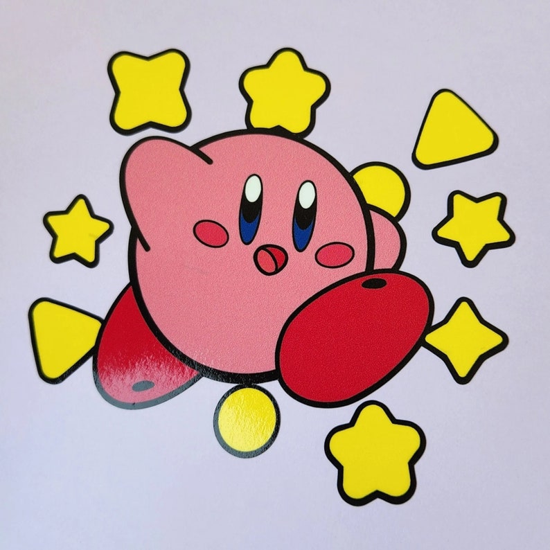 May include: A pink cartoon character with a red nose and blue eyes surrounded by yellow stars. The character is wearing a red hat and has a yellow star on its chest.