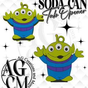 May include: Two green three-eyed alien soda can tab openers with blue and purple suits. The text SODA CAN Tab Opener appears in black at the top right, and a circular logo with the text AG Creations and More is in the bottom left corner.
