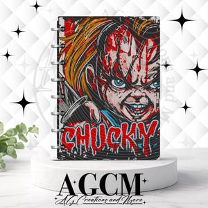 May include: A disc-bound notebook featuring a graphic illustration of the character Chucky with orange hair, blue eyes, and blood splatters on the face. The name CHUCKY is printed in large, red, dripping-style letters at the bottom of the cover.