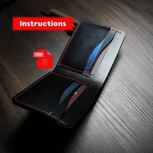 May include: Black leather wallet with red stitching, open to display card slots with blue and gray cards. The word "Instructions" is in a red rectangle. A red PDF icon is also visible.