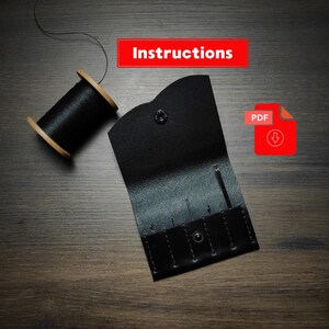 May include: A black leather needle case with needles, a spool of black thread, and the word "Instructions" in a red box. A red PDF icon with a download arrow is also present.