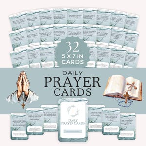 May include: A set of 32 daily prayer cards, each featuring a different scripture verse. The cards are 5x7 inches and have a watercolour background with a cross in the corner. The cards are displayed on a blue background with a Bible and rosary beads.