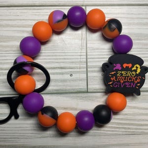 Pulsera de cuentas con forma de caldero Zero Amucks Given y clip para llavero