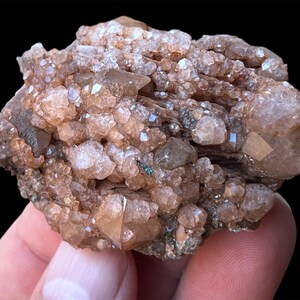 May include: A cluster of brown and clear quartz crystals with a rough, natural texture. The crystals are clustered together in a dense formation, creating a unique and interesting specimen.
