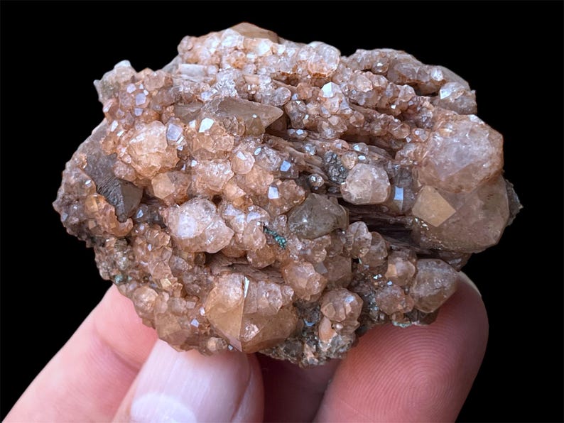 May include: A cluster of brown and clear quartz crystals with a rough, natural texture. The crystals are clustered together in a dense formation, creating a unique and interesting specimen.