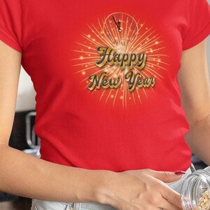May include: Red t-shirt with a gold graphic of fireworks and the text "Happy New Year".