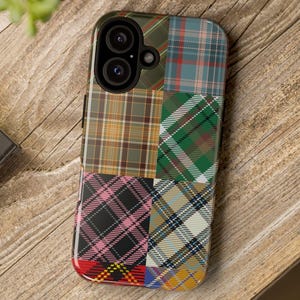 May include: A phone case with a patchwork design featuring various shades of green, blue, red, yellow, and black plaid patterns.