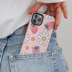 Pink iPhone case with strawberries, white daisies, and small yellow flowers