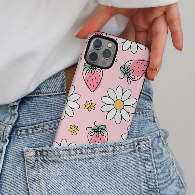 Pink iPhone case with strawberries, white daisies, and small yellow flowers