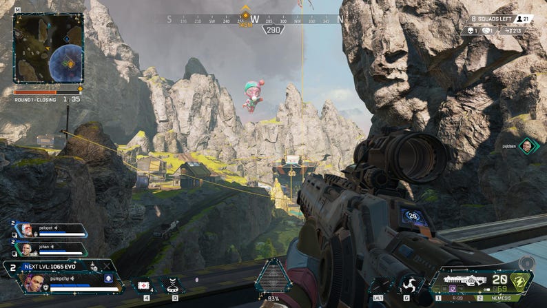 May include: A first-person view of a video game, showing a player aiming a gun with a scope at a distant target. The game's interface is visible, including the player's health, ammo count, and the number of squads remaining. The game is set in a mountainous landscape with a pink balloon floating in the sky.
