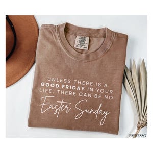 May include: A brown t-shirt with the text "Unless there is a Good Friday in your life, there can be no Easter Sunday" printed in white.