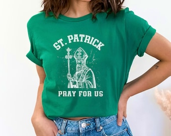 May include: Green t-shirt with a white graphic of St. Patrick and the text "St. Patrick Pray for Us".